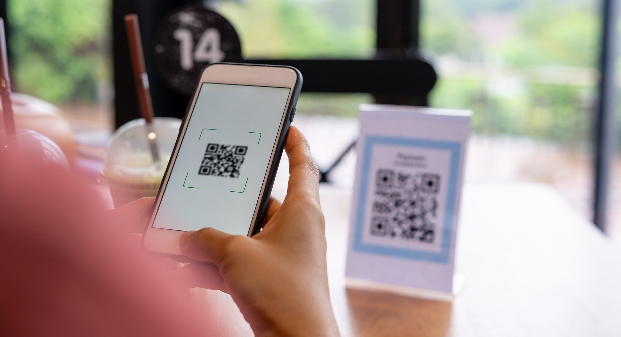 Person scanning QR Code in store to check-in